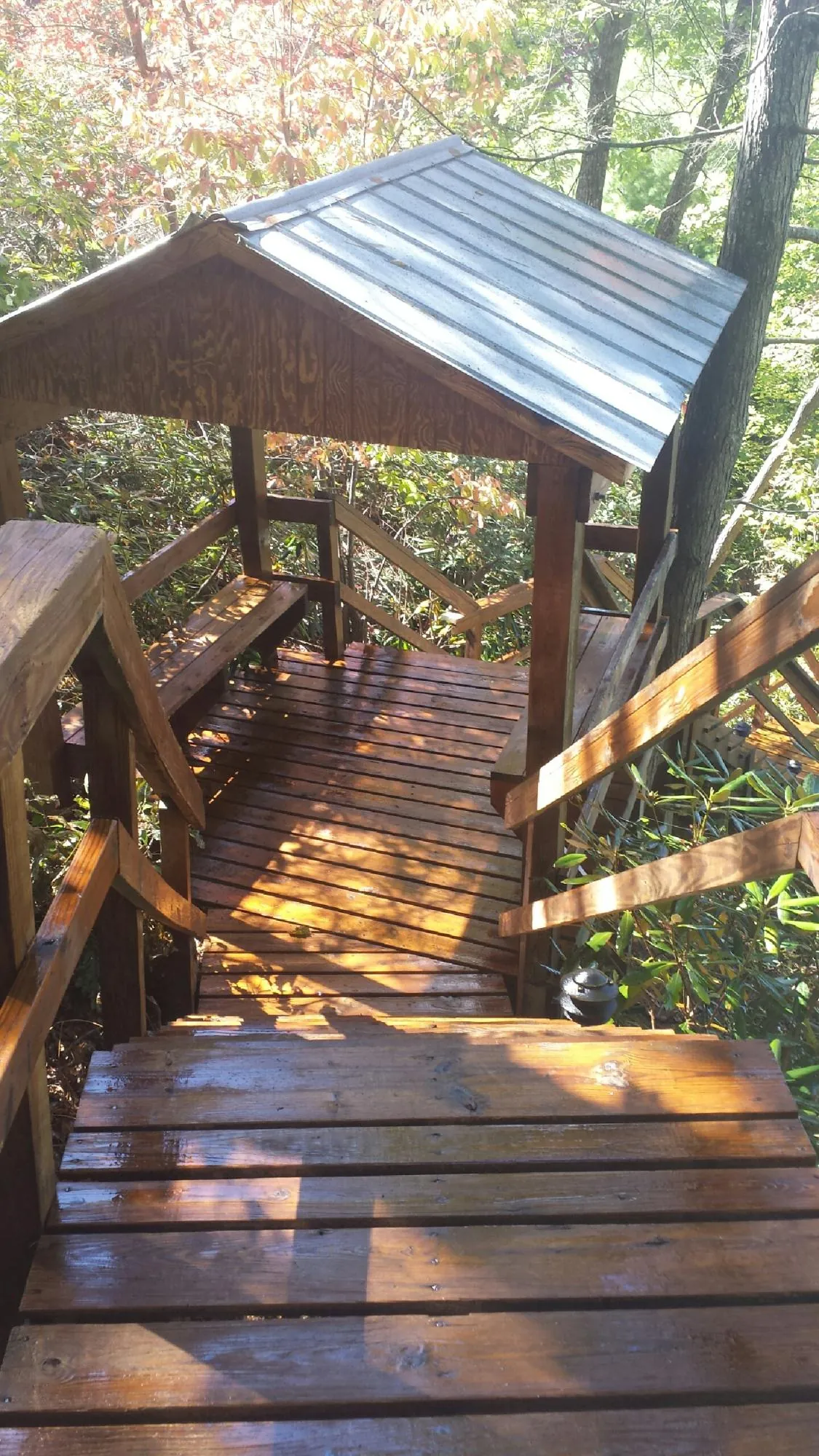 Freshly stained wood walkway and covered shelter with a metal roof in Electric City
